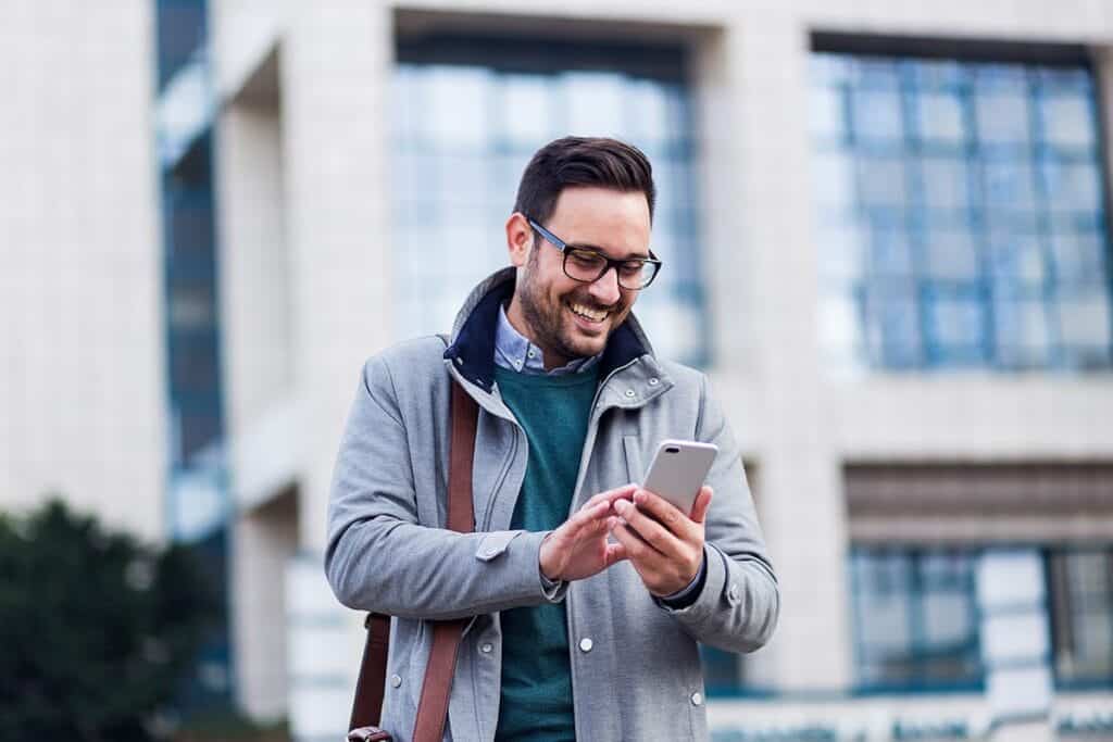 Man smiles while taking a selfie, feeling more confidence after residential drug treatment