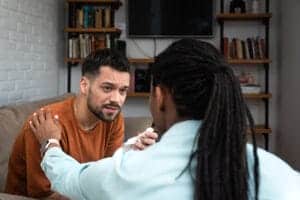 Woman comforts a peer in a medical detox treatment program