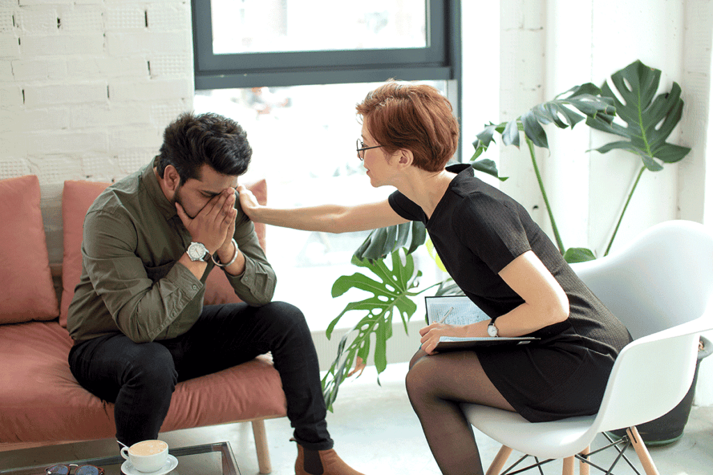 counselor comforting patient while discussing answers to the question how does prescription drug abuse occur